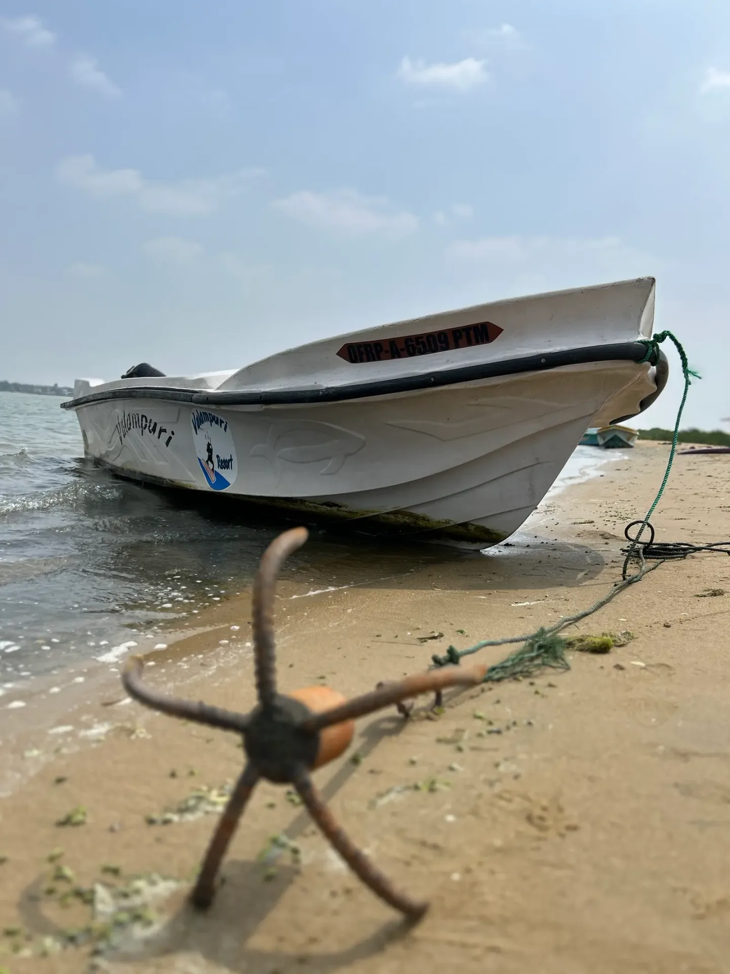 Boat anchored at a sandbar beach near Vella Island, Kalpitiya