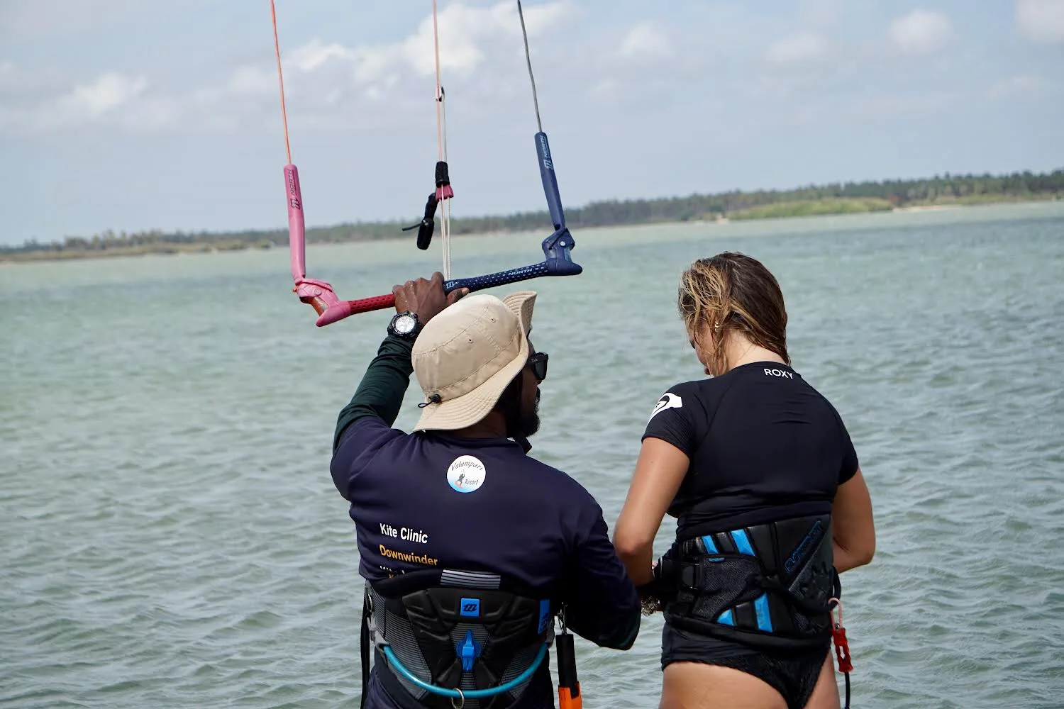 Instructor teaching a student kite control on Kalpitiya Lagoon