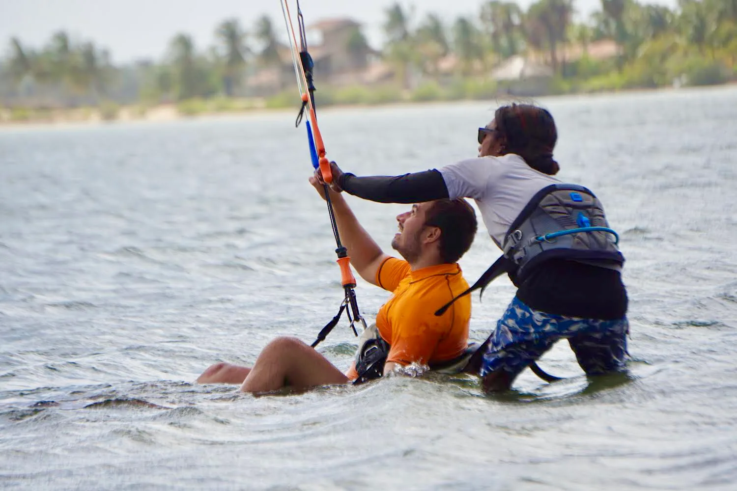 Instructor helping a student water start in the shallow water of Kalpitiya Lagoon