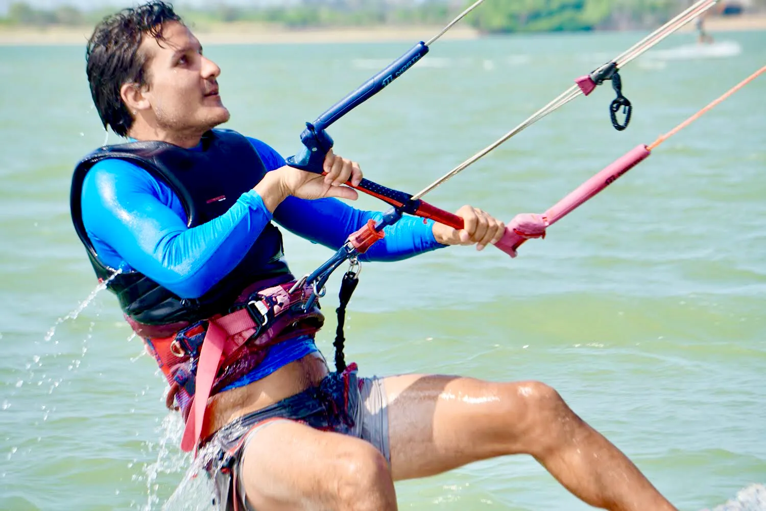 Student body-dragging across the flat water of Kalpitiya Lagoon